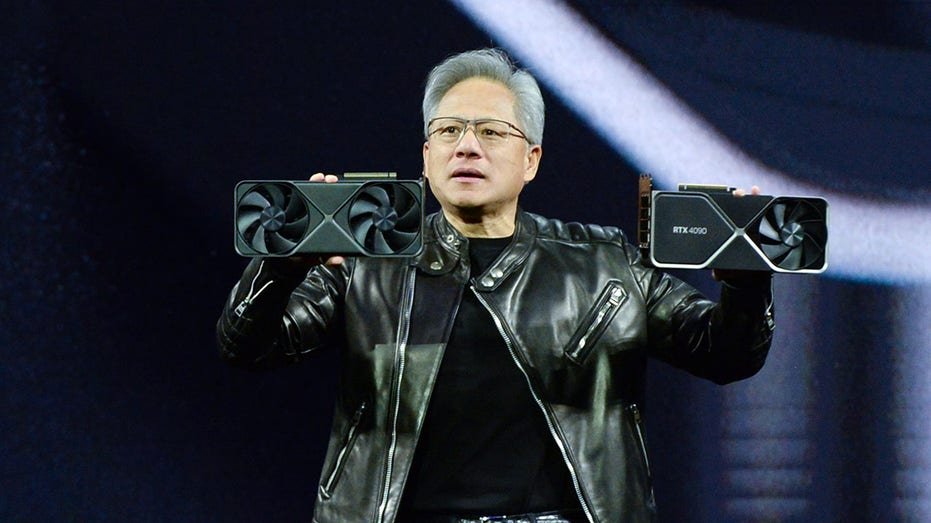 Huang holds NVIDIA graphics cards at the Ai Summit