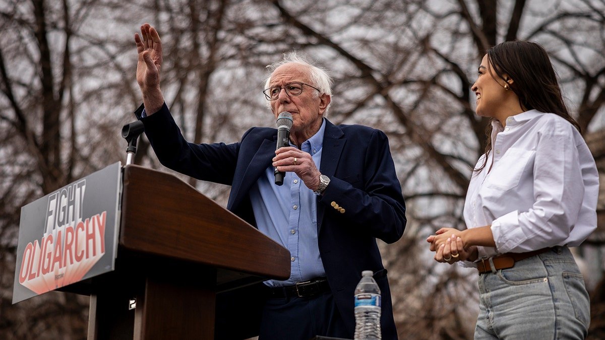 Senator Bernie Sanders gather together with AOC