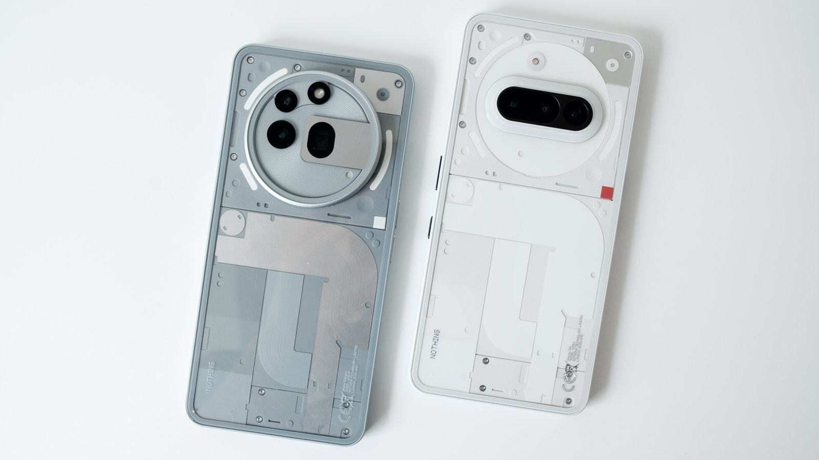 The Nothing Phone 3a and 3a Pro sit next to each other. 