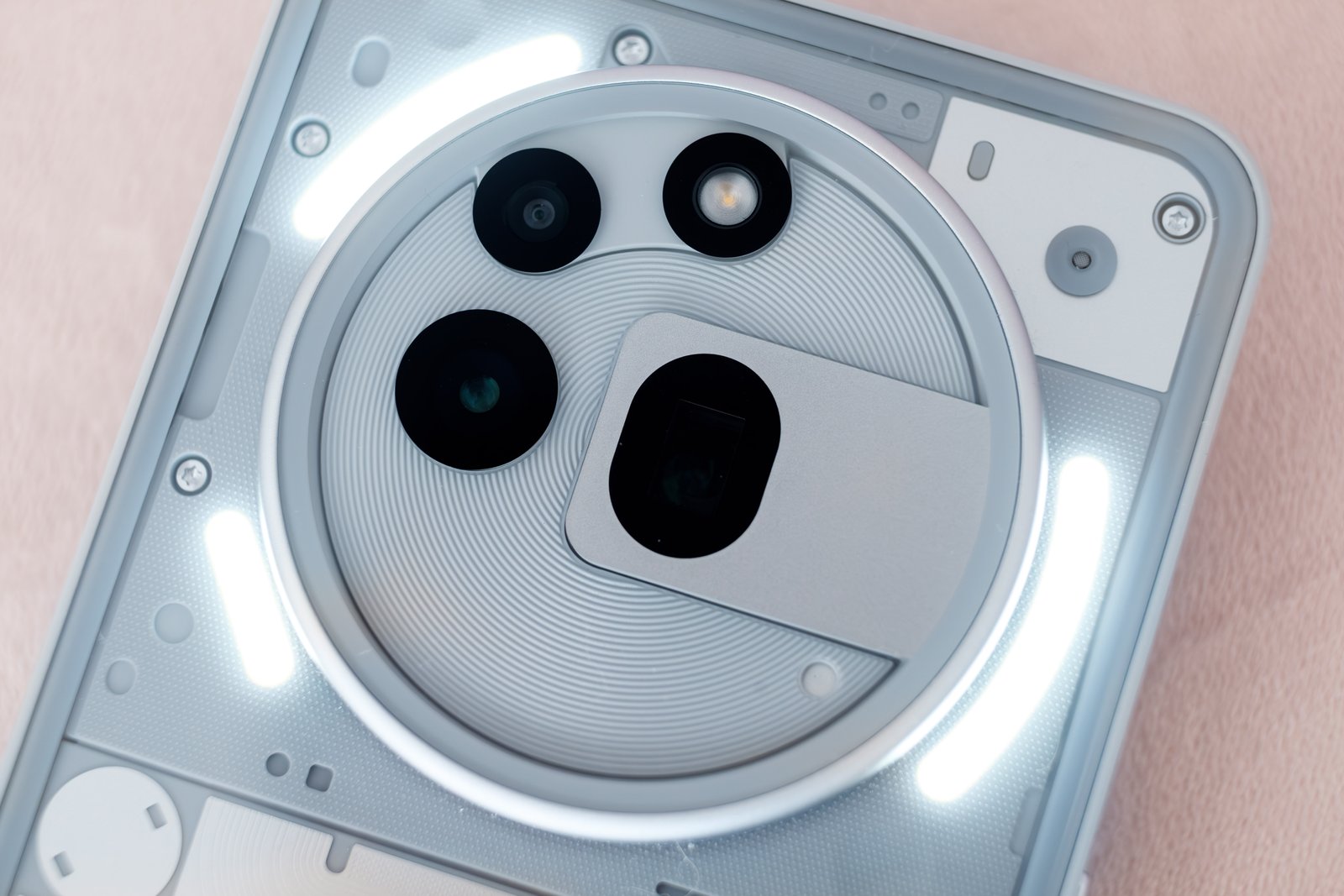 A close up of the Nothing Phone 3a Pro and its lit up Glyph array.  