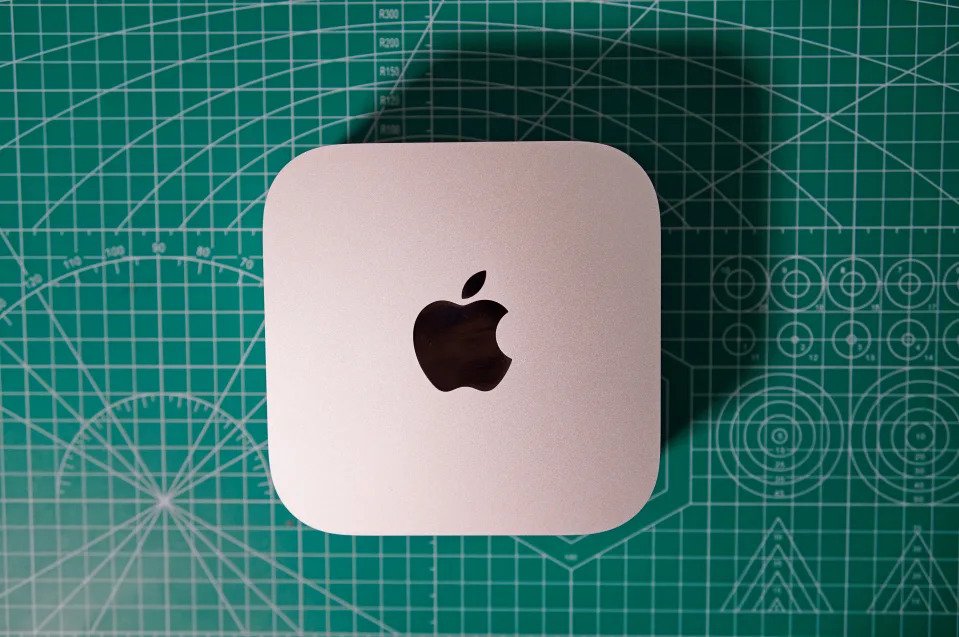 M4 Mac Mini is photographed on the green craft cutting board