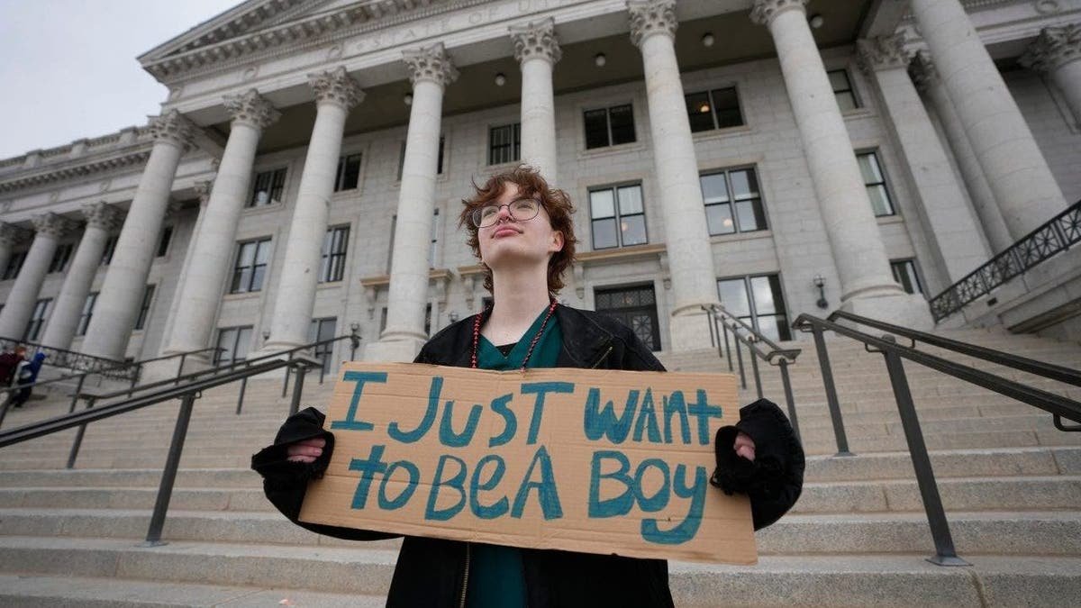 A transient child activist with an external cabetol sign
