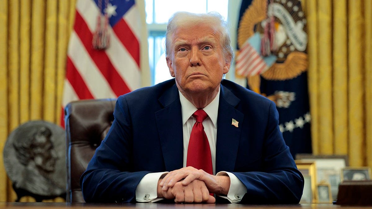 Trump sat behind the firm office