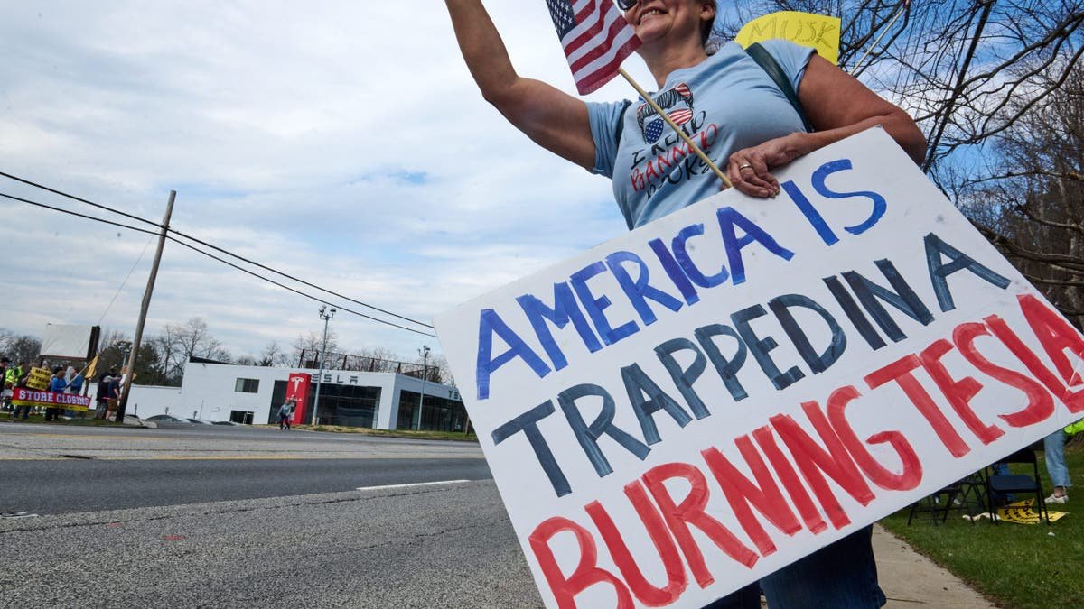 A woman protesting Tesla