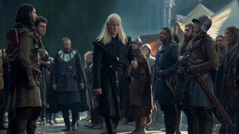 Daemon Targaryen stands in the middle of a group of soldiers in the dragon house