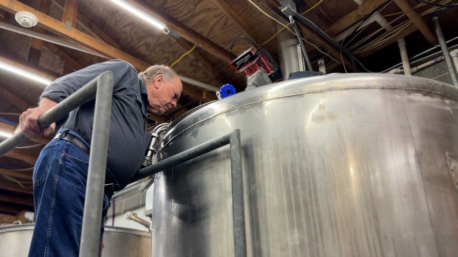 PHJIL PRICHARD monitors the distillation process.
