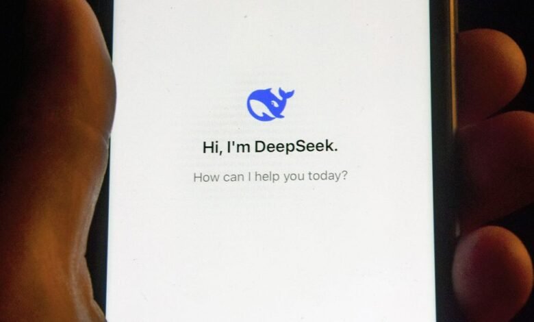 close up of a hand holding a smartphone with the deepseek app opened on the screen.jpg