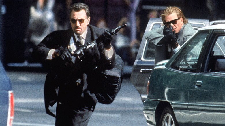 Neil Robert De Niro runs on the street while Chris Fal Kilmer covers him during the shooting fire