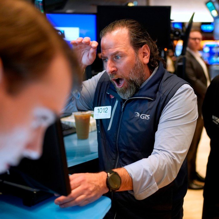 Merchants work on the New York Stock Exchange floor