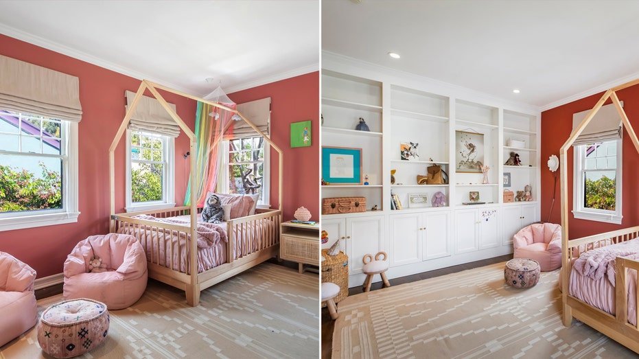 A bedroom has a pink walls and a small bed.