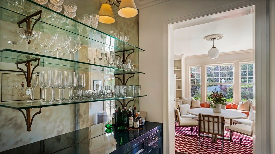 The kitchen also features a serving store, which includes glass shelves.