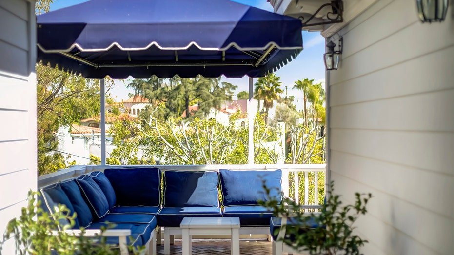 The second floor courtyard works as an outdoor seating area and looks down the backyard.