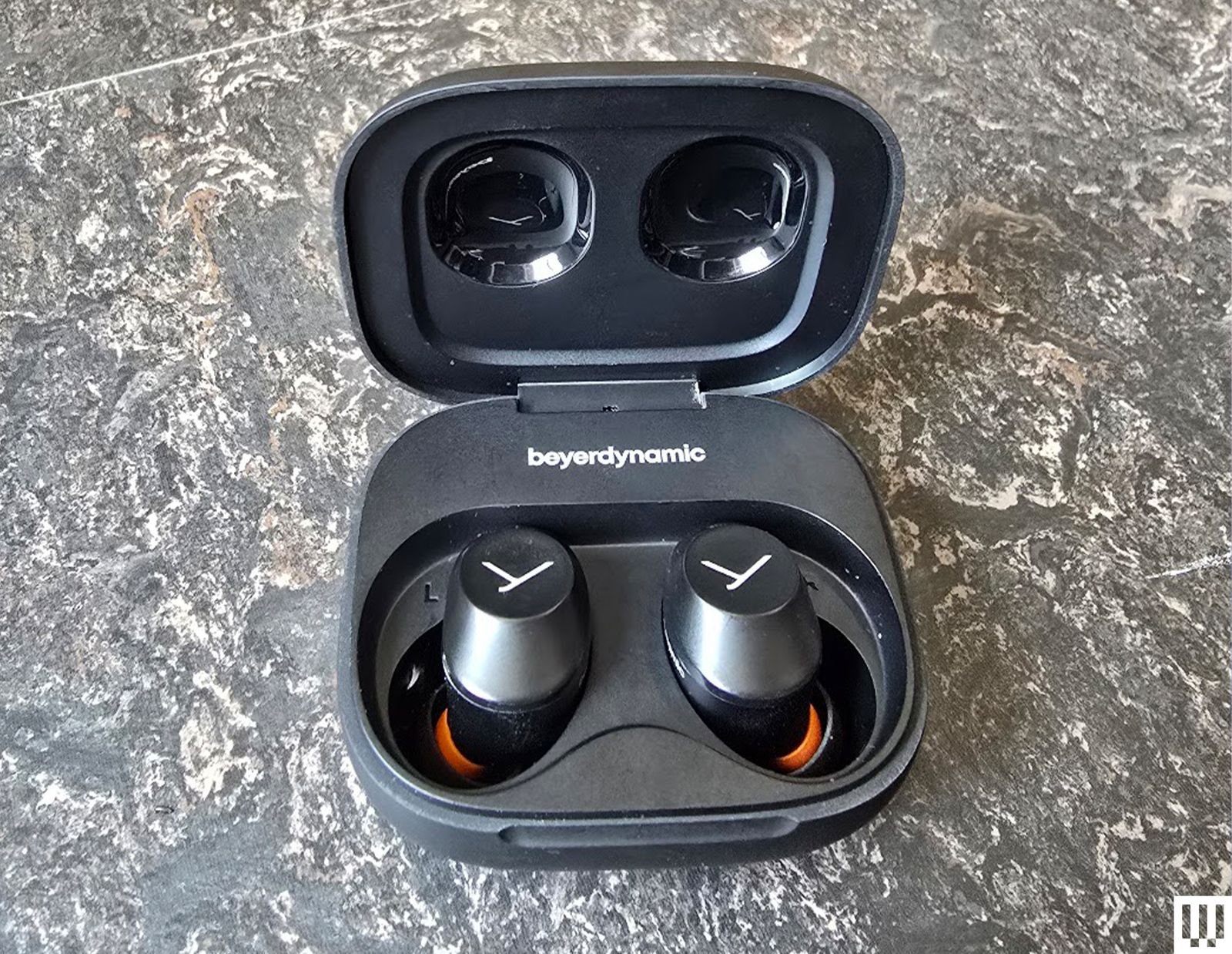Beyerdynamic Amiron is open with earphones in the case on the marble table