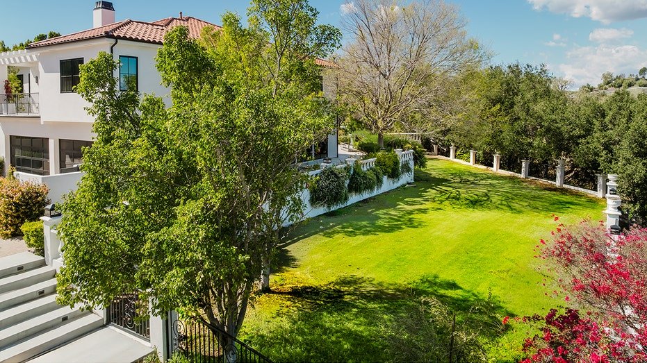A group of stairs leads to a large herb area in the backyard.