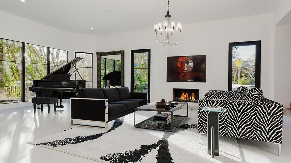 The living room at home is found on the basement, and it features a fireplace and a brutal donkey print sofa.