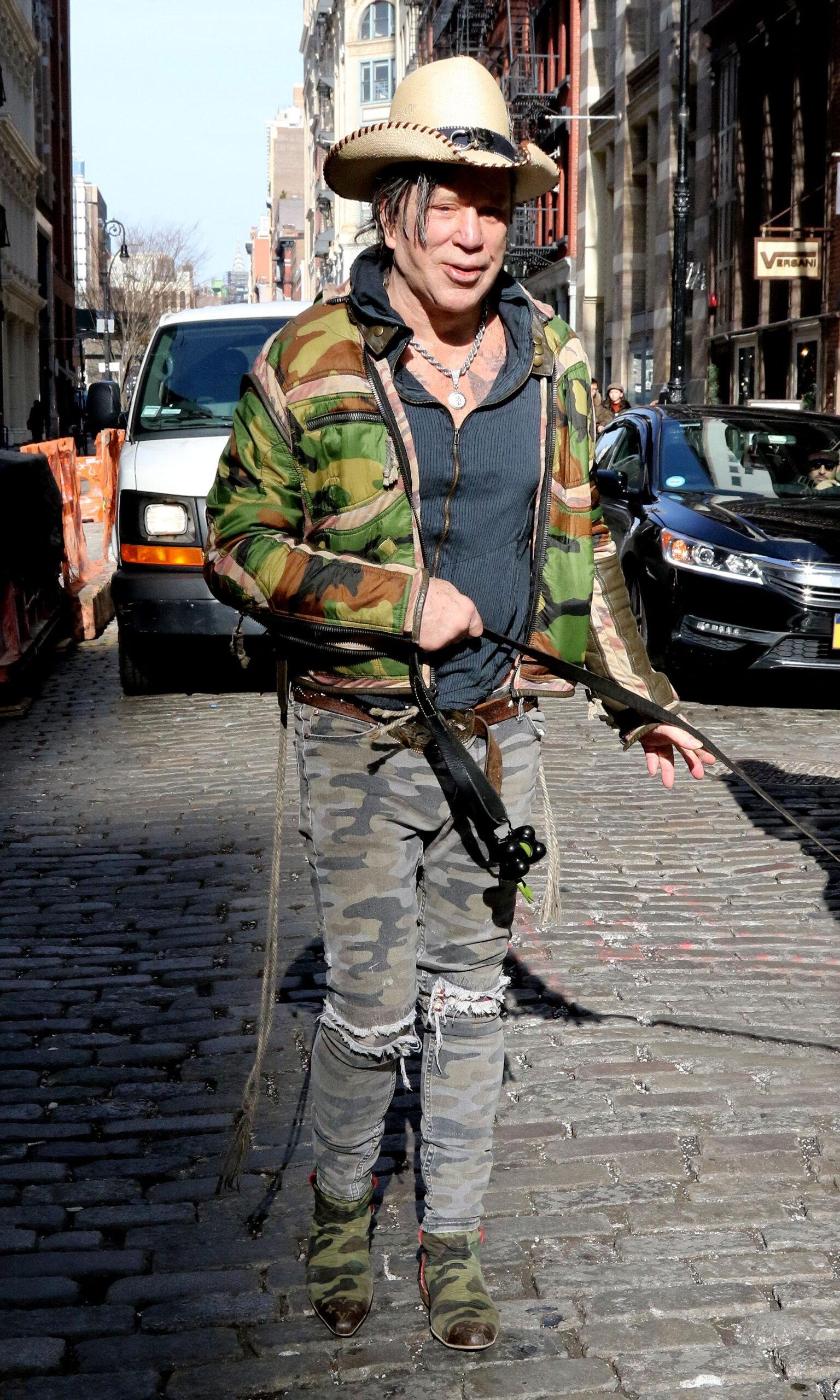Mickey Rark is all smiling wandering with fans and carrying his dog in New York City