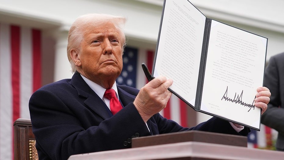 President Donald Trump holds a signature executive