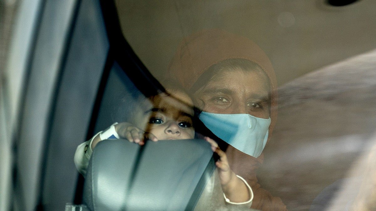 Afghan refugee holds the child