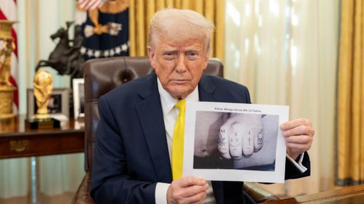 Trump holds a picture showing Garrisia's hand with tattoos
