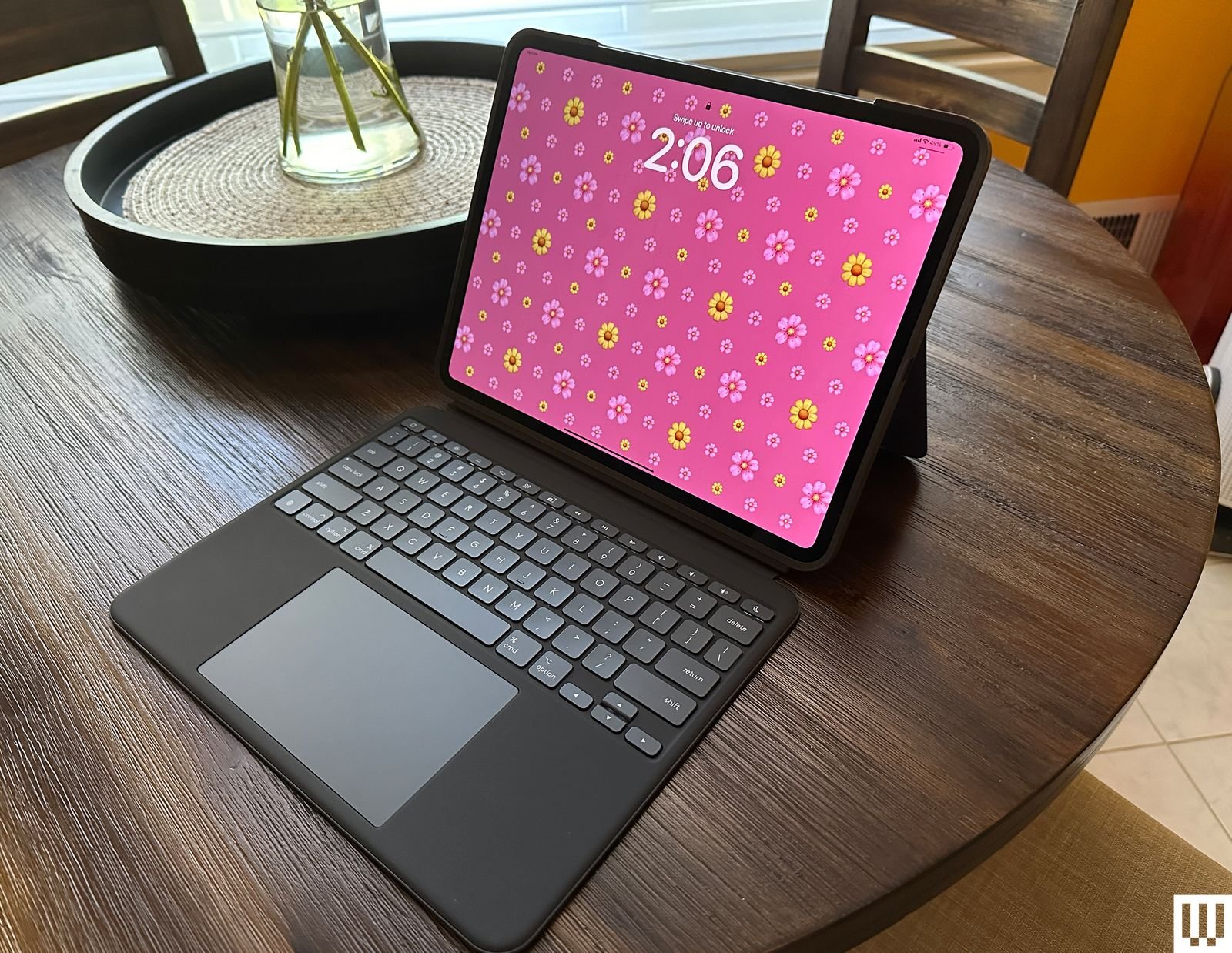 Logitech Combo Touch Black tablet device supported on white kickstand connected to a separate black keyboard