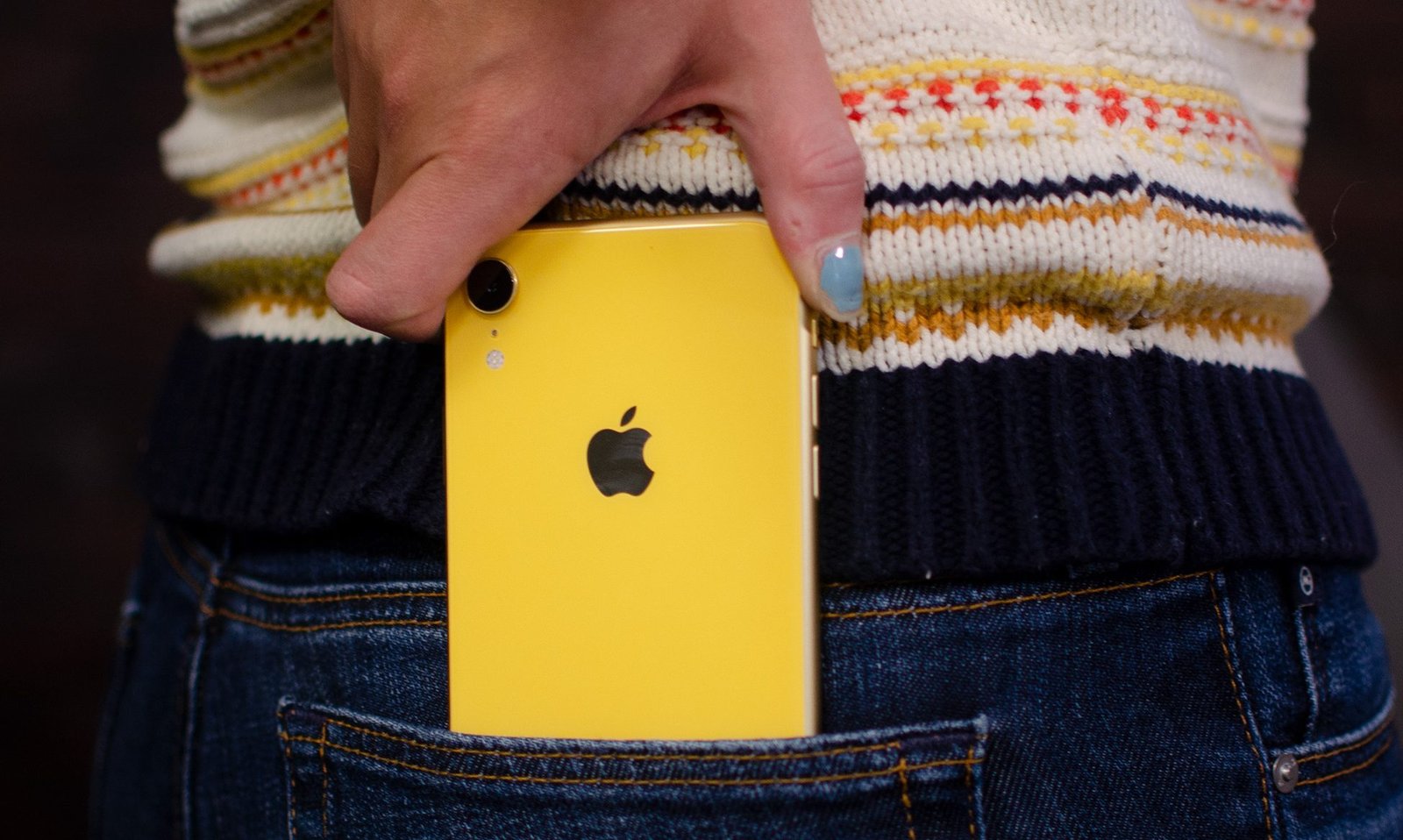 A person takes iPhone from his pocket.
