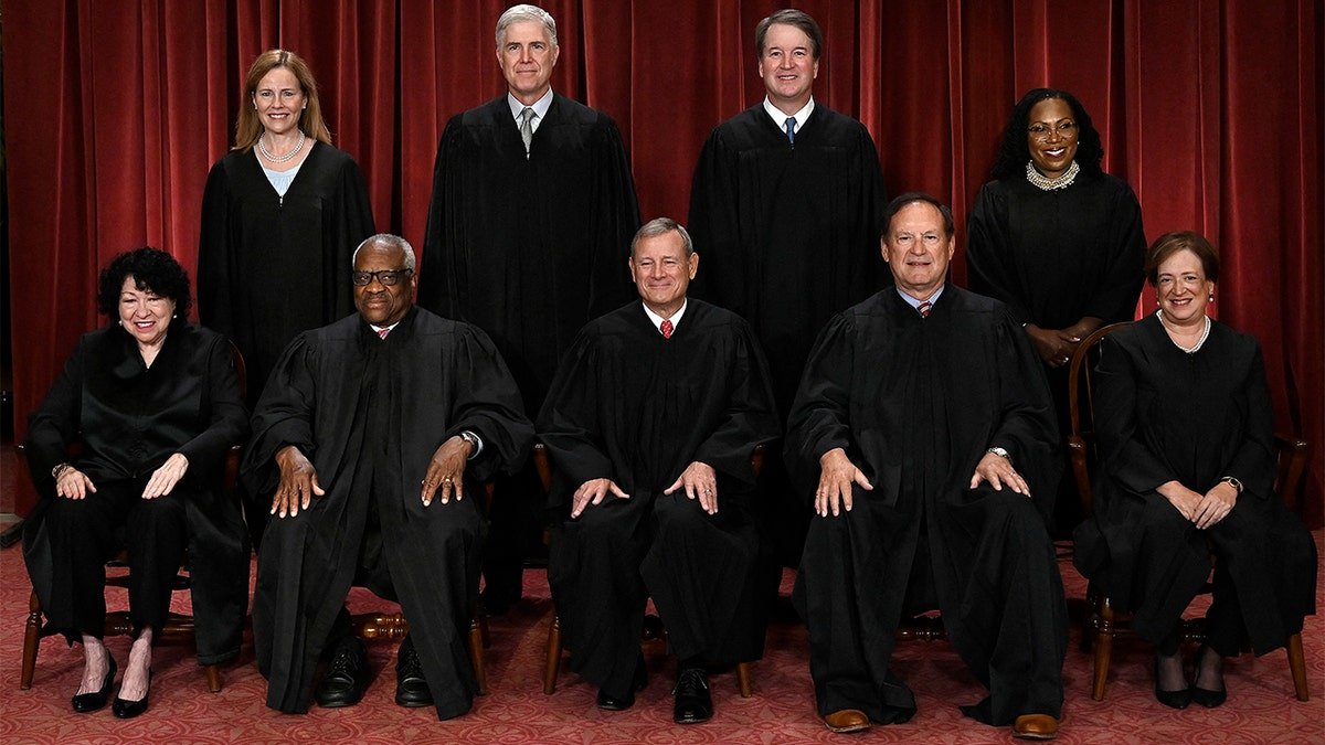 Supreme Court judges sit for a picture.