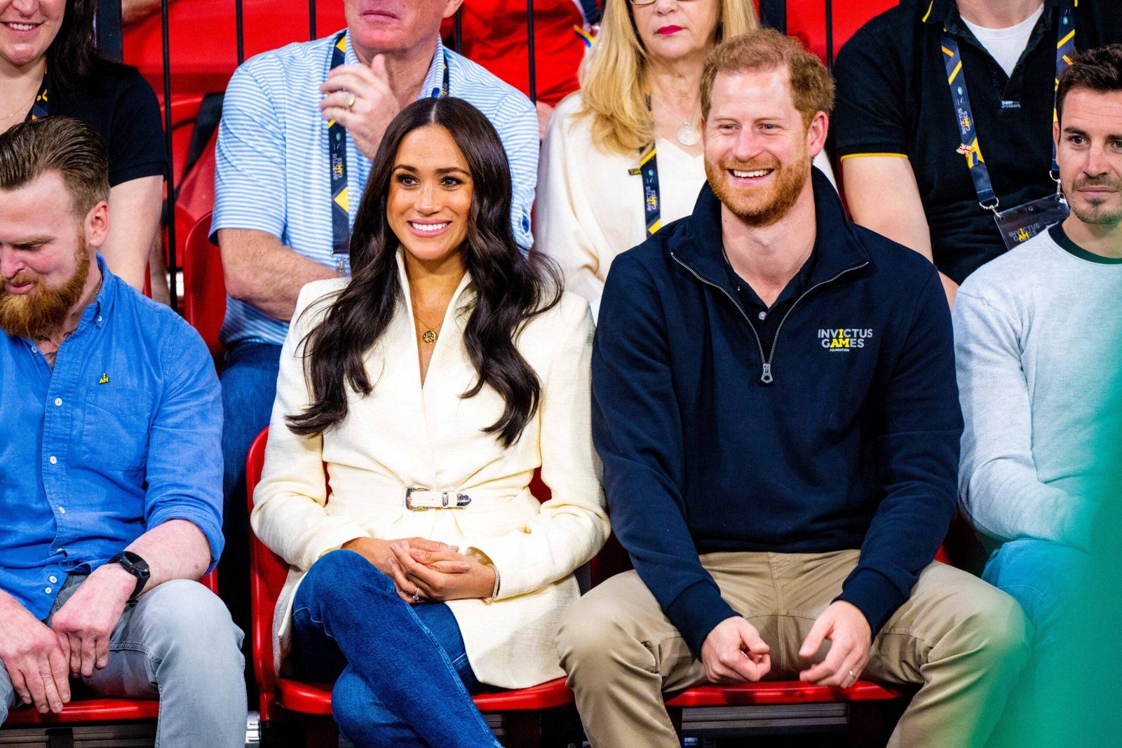 Prince Harry and Meghan Markle sit together