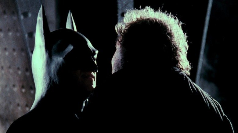Michael Keaton Batman holds a bullying near his face in Batman