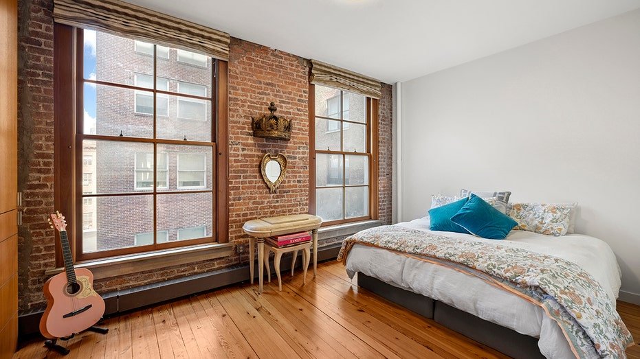 The bedroom features brick and adult walls.