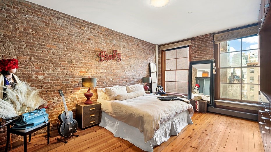 The basic bedroom features city views as well as an entertainment center.