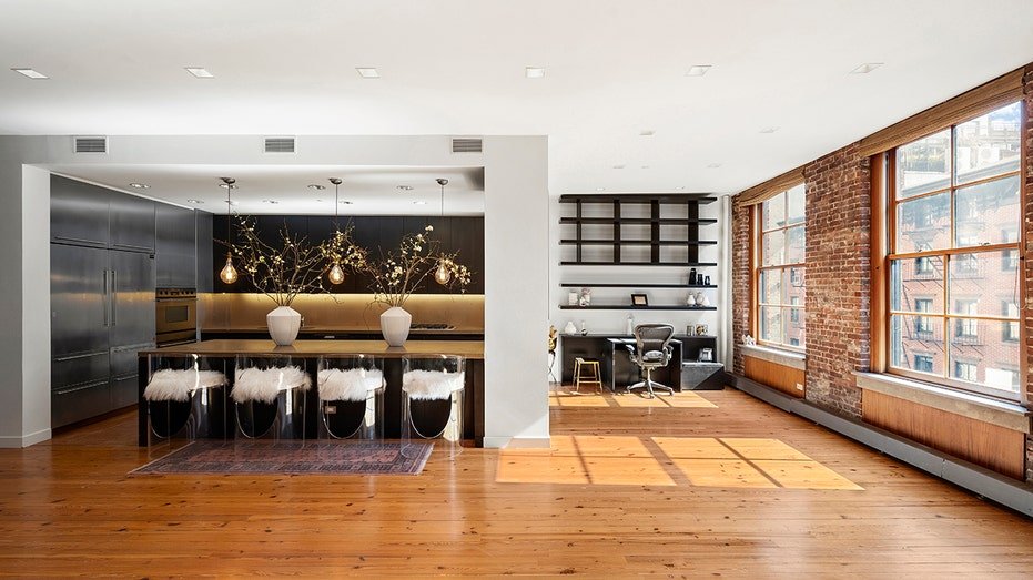 The kitchen and a small office are found against the living room.