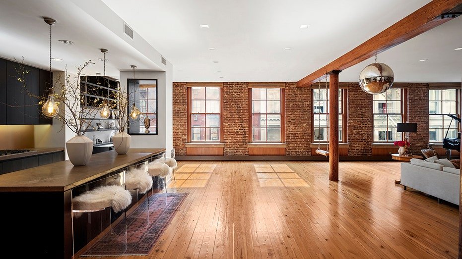 Wooden beam columns separate the living room from the kitchen.