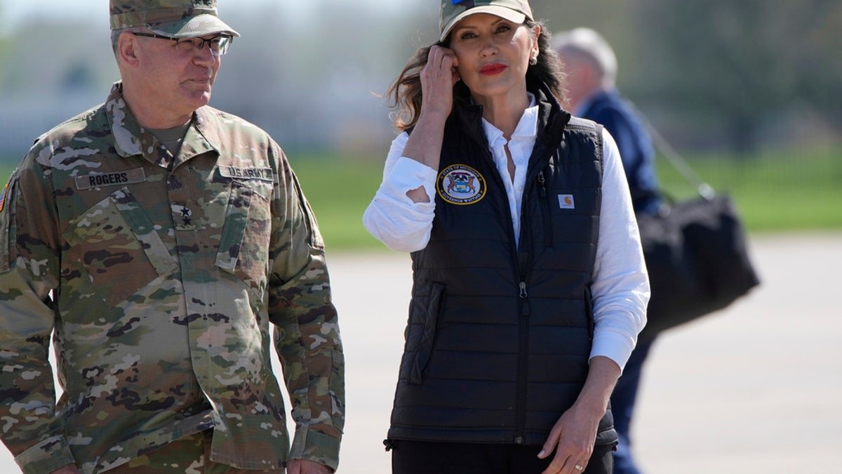 The governor of Michigan Grechen and passes through the National Guard in Michigan Major General Paul Rogers at the National Guard Base Silfredge, on Tuesday, in the town of Harrison, Michigan.