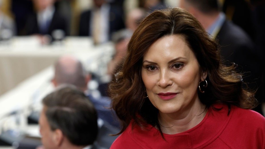 The governor of Michigan Gretchen and who is attending a meeting in a red blouse