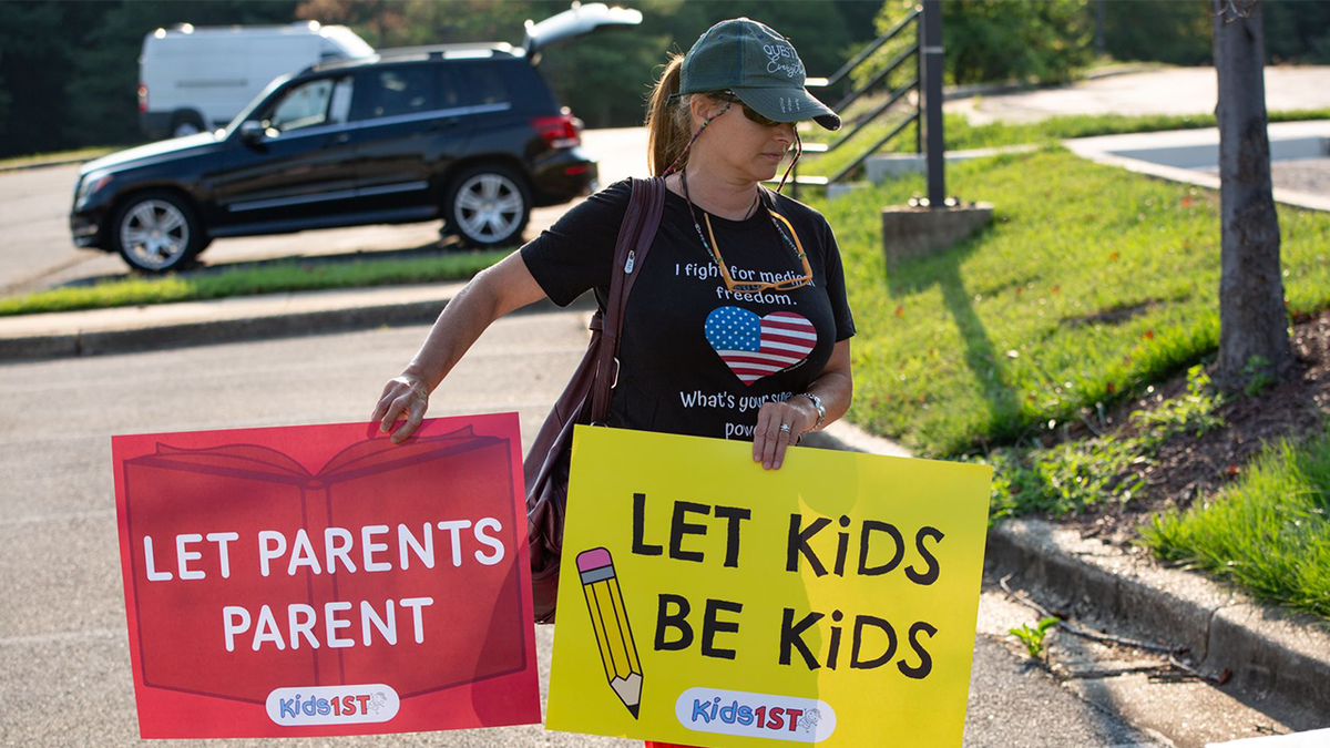 A woman with signs of protest