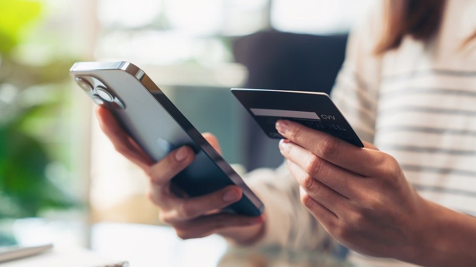 A woman bearing a credit and phone card