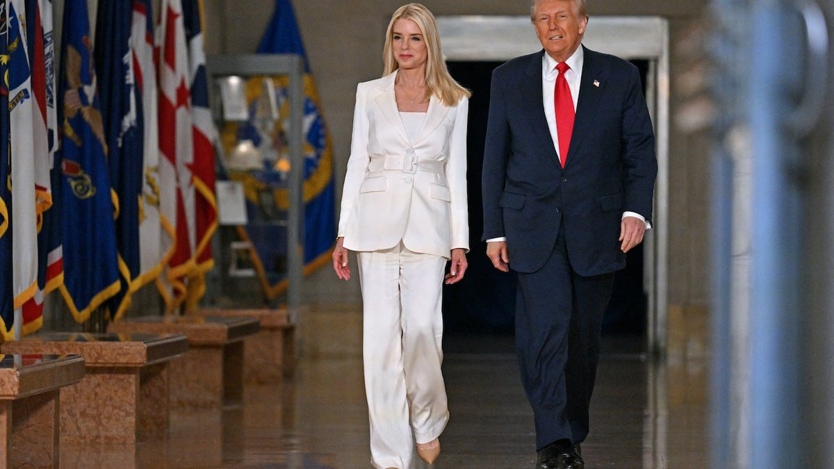 US President Donald Trump and US Prosecutor Bam Bondi (L) arrives to speak at the Ministry of Justice in Washington, DC (Roberto Schmidt/AFP via Getty)