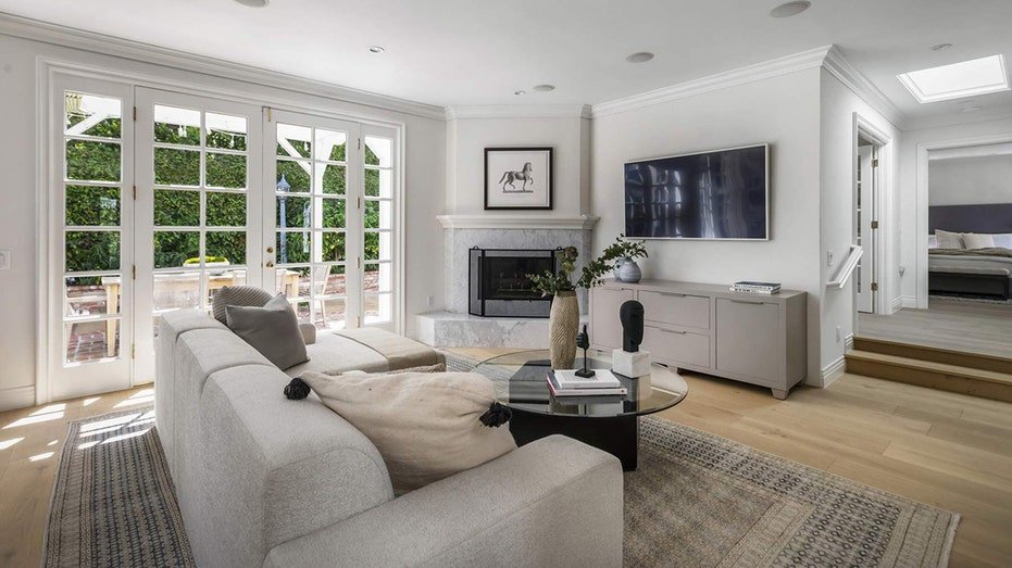Steps away from the food area is the living room that features a fireplace.