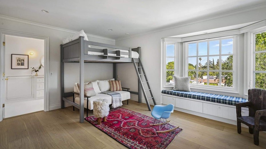 One of the bedrooms features a top bed and a seat filled under the window.