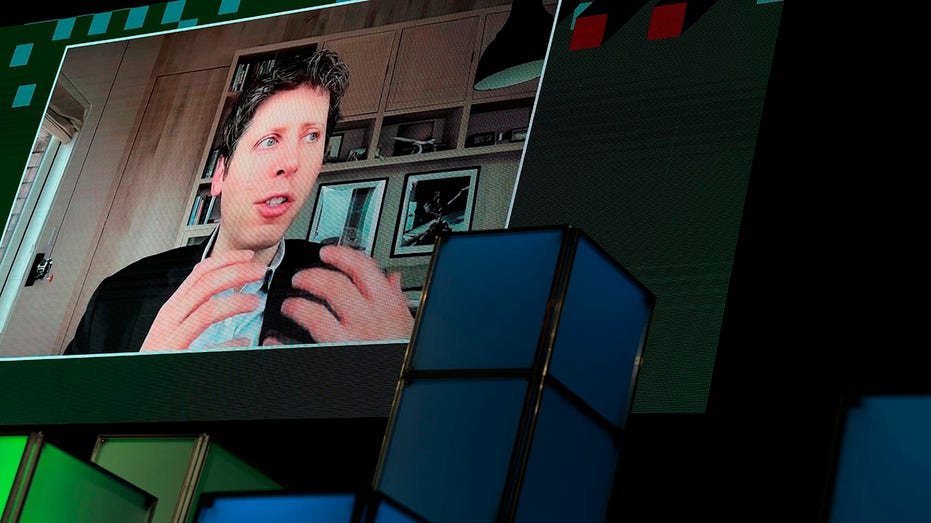 Sam Altman on a screen talking about a dimension to the DC AI conference