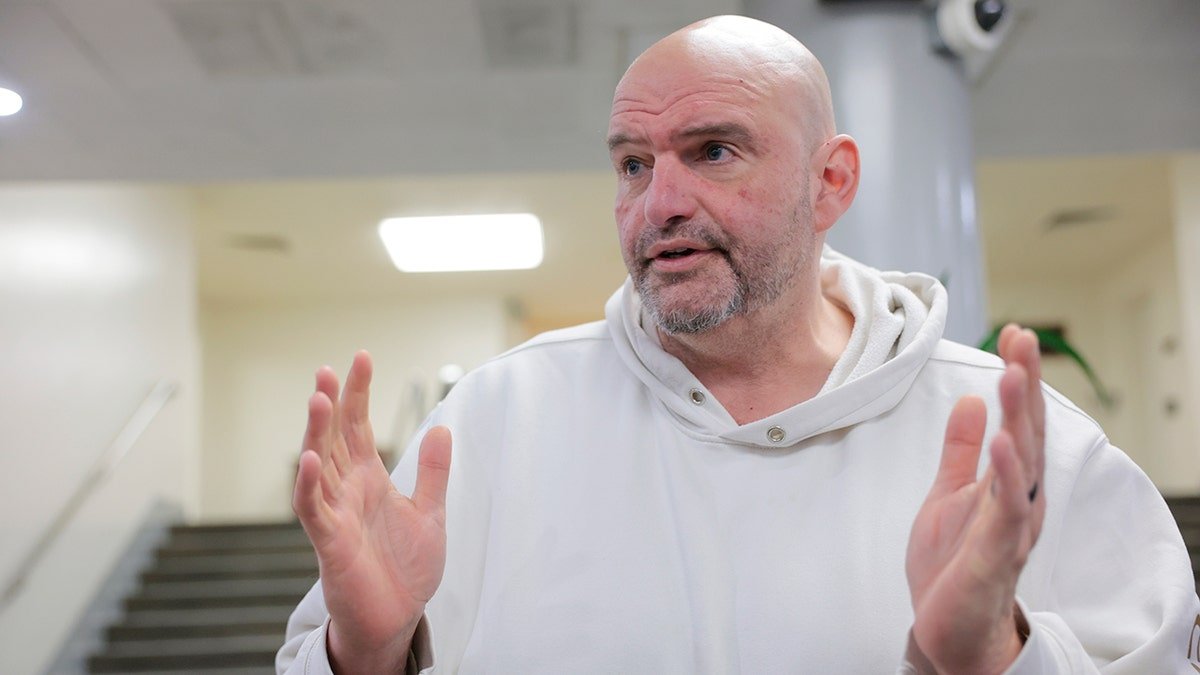 Senator John Vitirman wears a white Hoodie