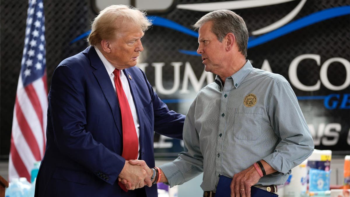 The President now Donald Trump shakes his hands with the governor of Georgia Brian Kemp on October 4, 2024, in Evans, Georgia.