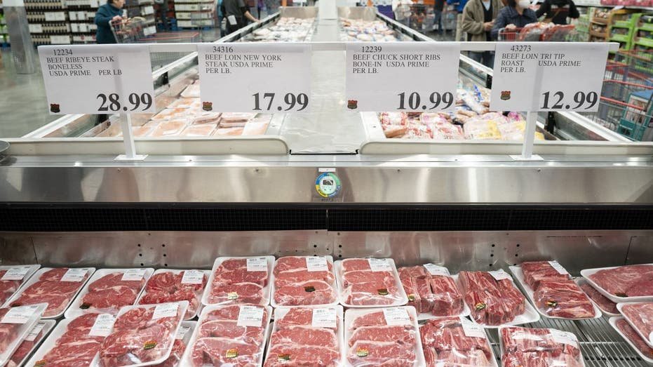 Price signs in the grocery store on different bottled meat