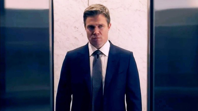 Stephen Emile in the role of Black Ted stands in an elevator on Los Angeles suits