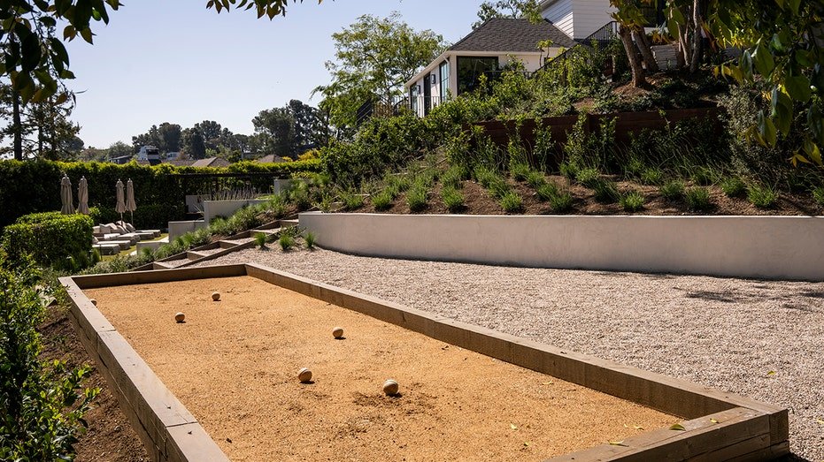 The rear courtyard also features a box football field.