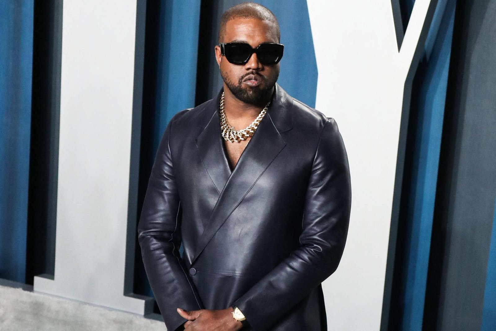 Kanye West wears a black suit