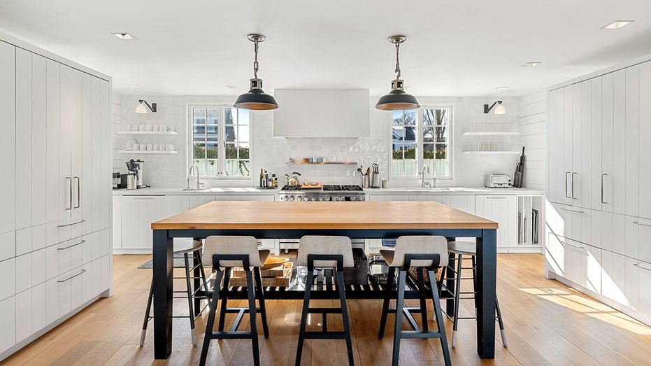 The kitchen features a large central island, custom tanks and a dual oven.
