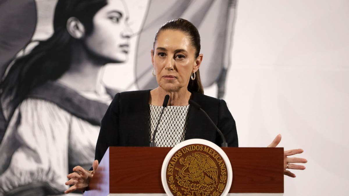 The Mexican president speaks on the platform while wearing black clothes