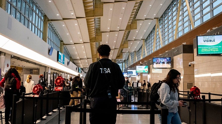 The passengers walk after the TSA agent at Ronald Reagan Airport