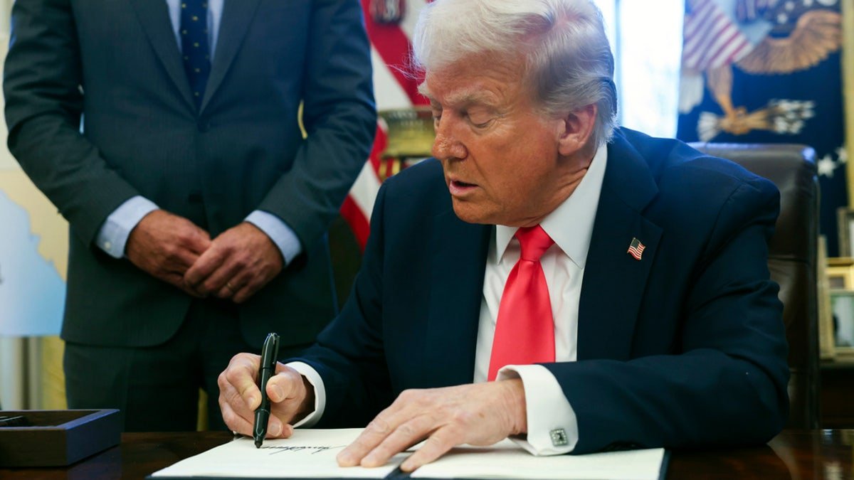 Trump signs the executive order at the White House
